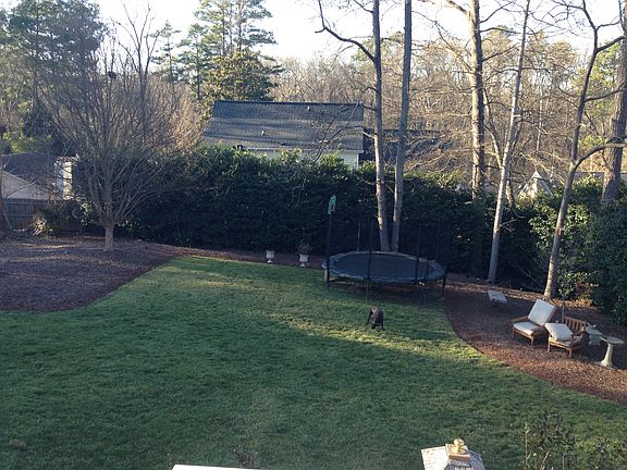 Open back yard w/trampoline