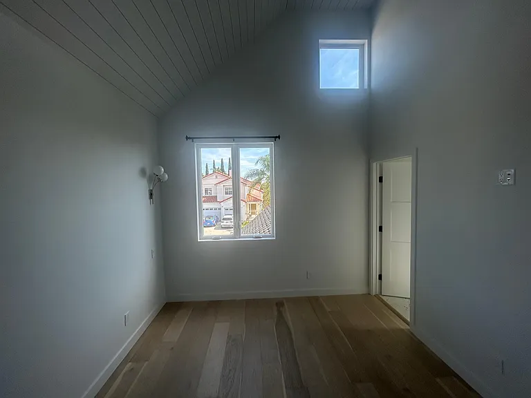 Bedroom with oversized windows high ceilings and walk-in closet private bathroom