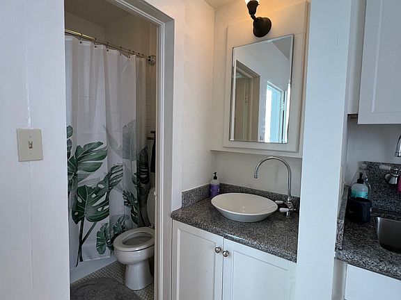 Bathroom with shower and adjacent sink