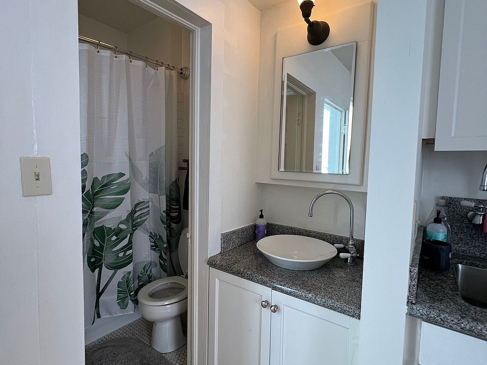 Bathroom with shower and adjacent sink