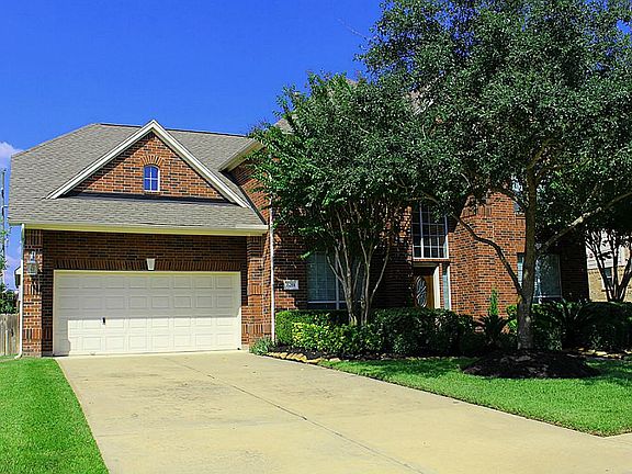 The 2-car garage is nicely tucked away behind a 3-foot deep porte-cochere.