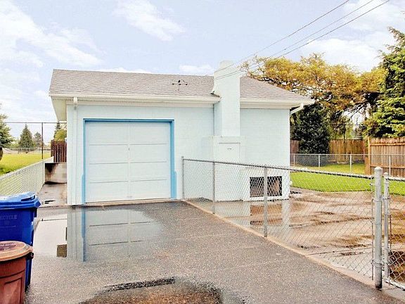 Front of the garage. Controls for sprinkler system in garage. Storage above.