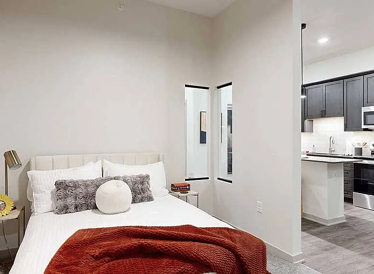 Our Fox studio includes a privacy wall that defines the sleeping area, offering the feel of a separate bedroom within a studio layout.
