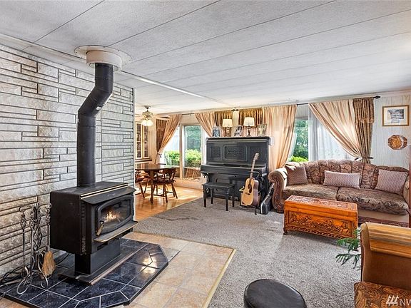 Throw some fire logs on, sit back, and relax. Living room connected to formal dining room. Light, bright, and open.