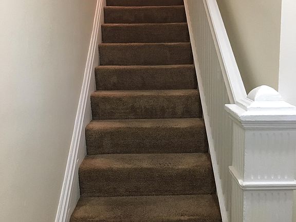 Stairway from the front porch up to the main living level.