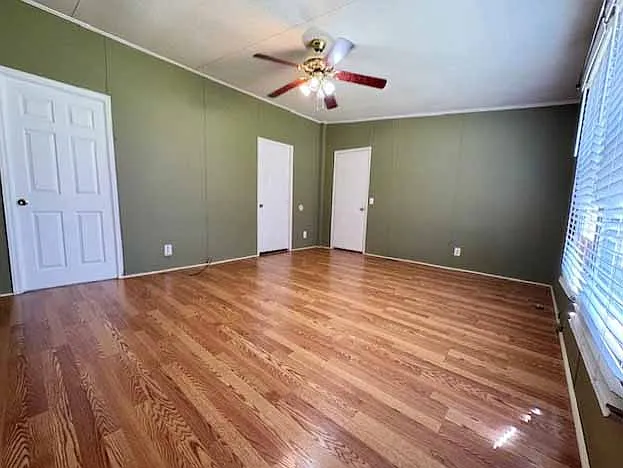 Spacious primary suite with two large windows that fill the room with natural light. Easily accommodates a king-size bed, two nightstands, and additional furniture. Features a huge walk-in closet and a private en-suite bathroom with double vanities,