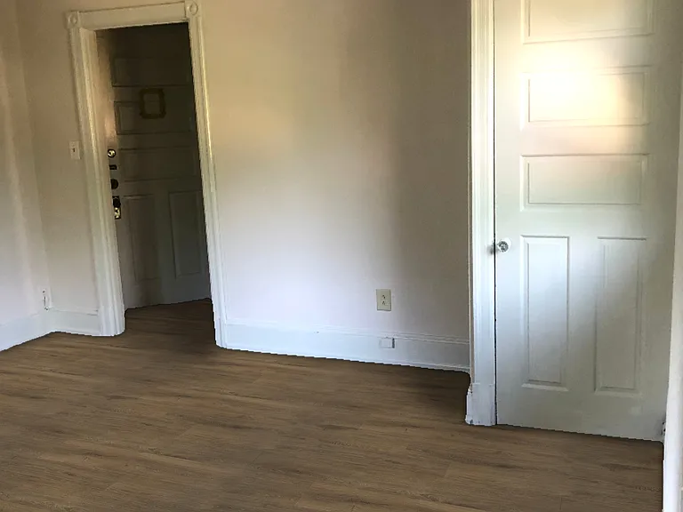 Large living room with closet, high ceilings, and great natural light.