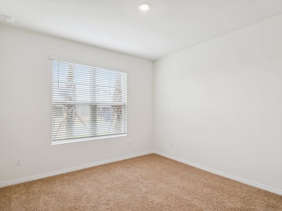 First bedroom downstairs with en suite bathroom at front of home.