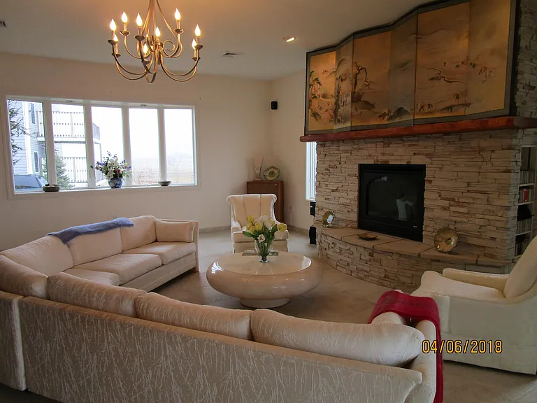 living room seating arrangement fronting gas fireplace