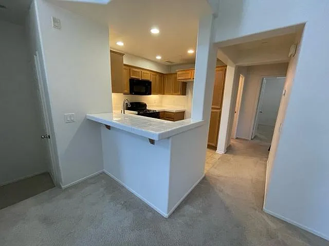 Kitchen and hallway to guest bath and bedrooms