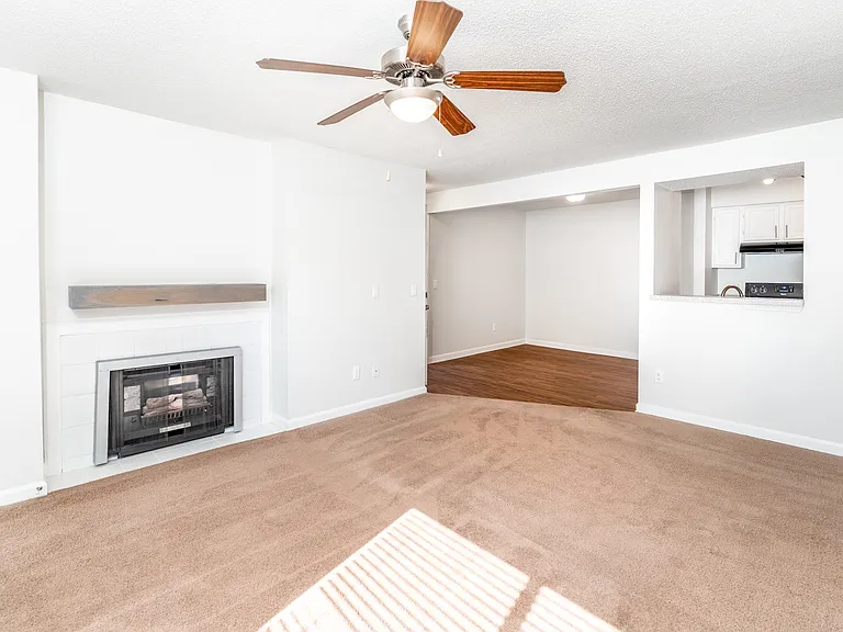 Living Room Featuring Modern Gas Fireplace with Mantle - Gold Interior