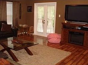 Pretty hardwood floors in family room - Opens on to the front porch.