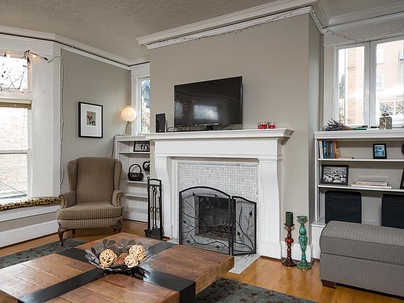 Living room with smart TV, bay windows