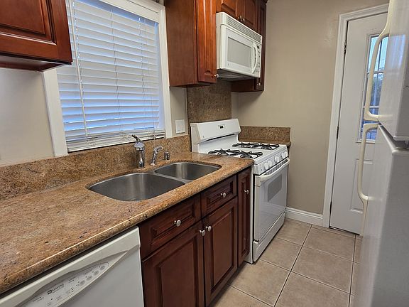Full kitchen with gas range, microwave, dishwasher, refrigerator, washer/dryer & garbage disposal.