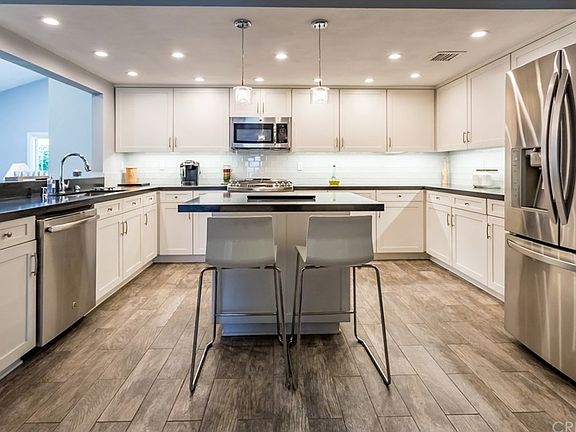 Incredible kitchen with tile flooring, quartz coun