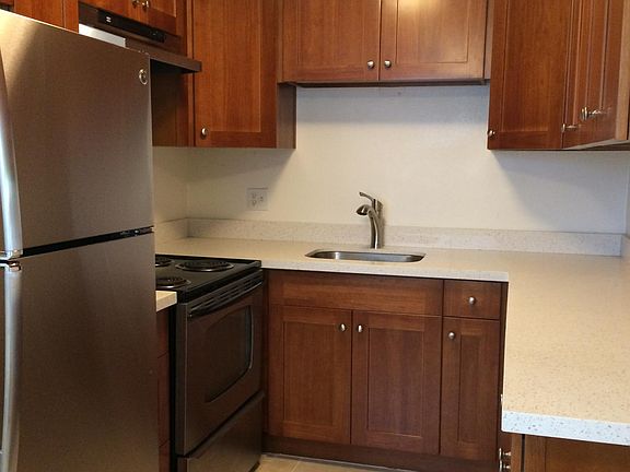 Kitchen with stainless appliances, quartz counters