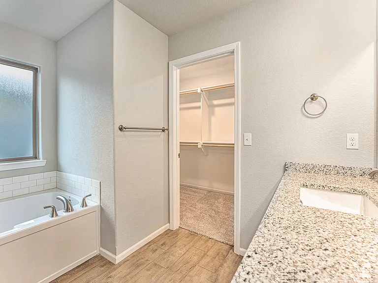 Primary bedroom's bathroom with walk-in closet
