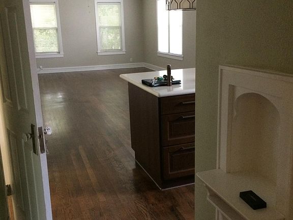 View from hallway with original tulip phone shelf. The unit has central air and heat but also ceiling fans for more pleasant days.