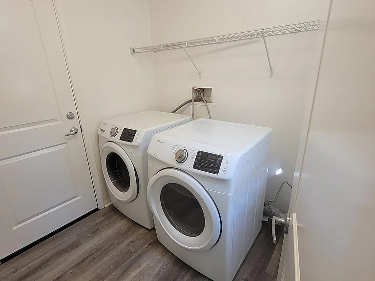 Laundry room, leading from the foyer, into the direct access private garage.