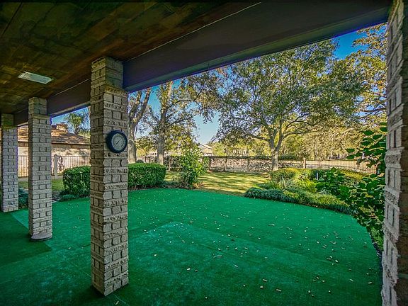 Back porch is covered and has easy care astroturf. Enjoy sitting here every day enjoying your golf course views