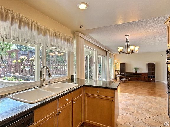 Kitchen is fully open to eating area & sizable family room. Light-filled eastern exposure wall of windows!