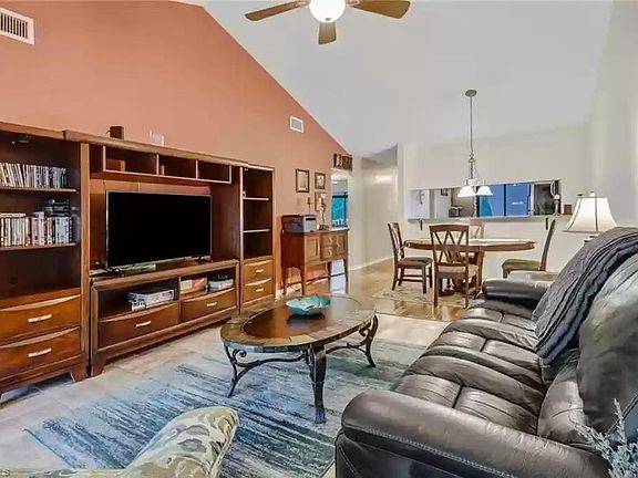 Spacious living room with reclining chair and reclining leather sofa, TV, board games, office laser printer, ...
