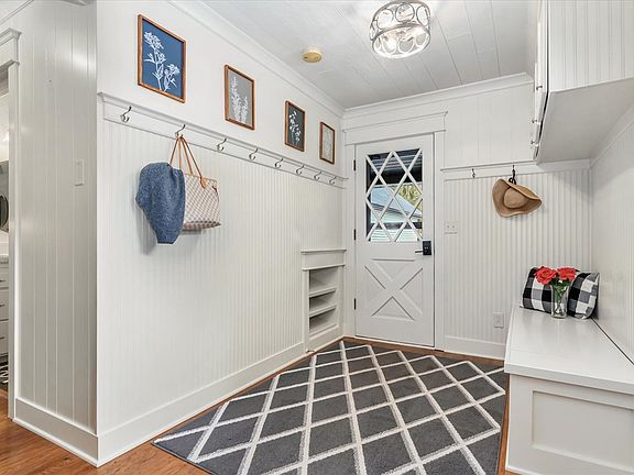 Step into a welcoming entryway with timeless shiplap walls and classic charm_perfect for shedding jackets and boots after a brisk day outdoors. Thoughtfully designed for warmth and function, it's a cozy first impression that feels like home.