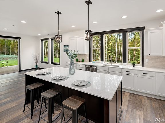Open kitchen features oversized island with eating bar.