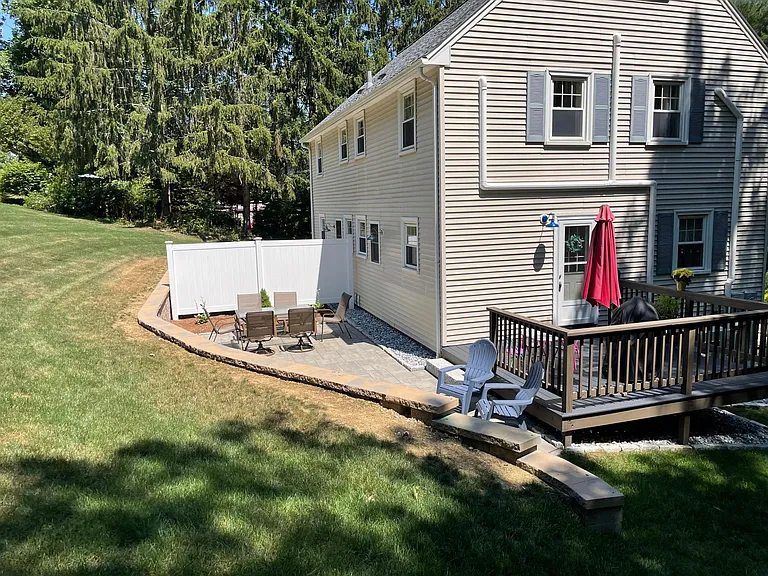 Back of the house with yard, patio and side deck