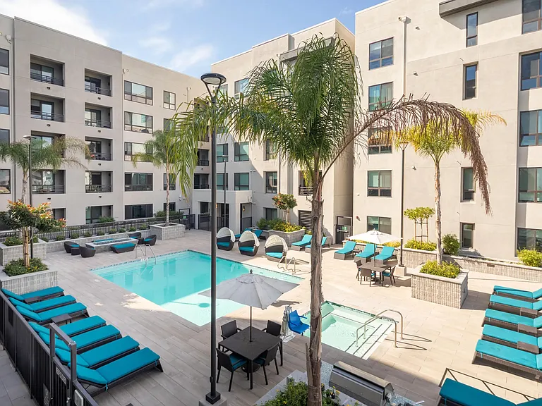 Sunny pool deck with cabanas, daybeds, and plenty of space for relaxed downtime.