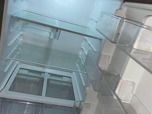 Inside of professionally cleaned stainless steel refrigerator