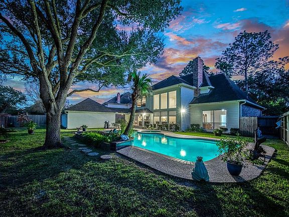 This gorgeous home is nestled among mature trees and beautifully landscaped grounds in the exclusive neighborhood of Windsor Park Estates.