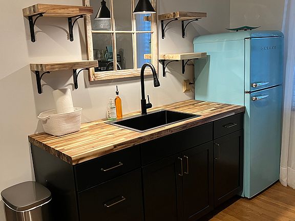 Kitchen furnished w/ convection oven, microwave, 2 burner stove top, blender, coffee maker, toaster, mixer and all cooking & serving utensils.