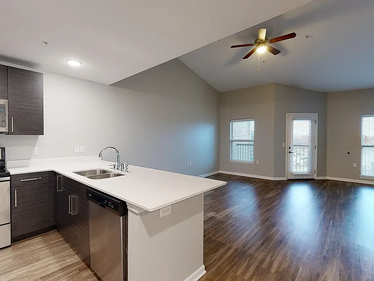 The Sycamore includes an open-concept floor plan with wood-style flooring, a ceiling fan, and natural light in the living space. The Sycamore includes an open-concept floor plan with wood-style flooring, a ceiling fan, and natural light in the living spac