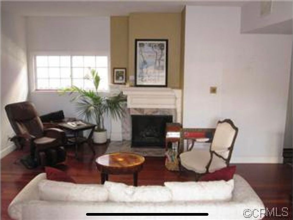 Living room with hall leading to coat closet, half-bath and stairway to attached garage.