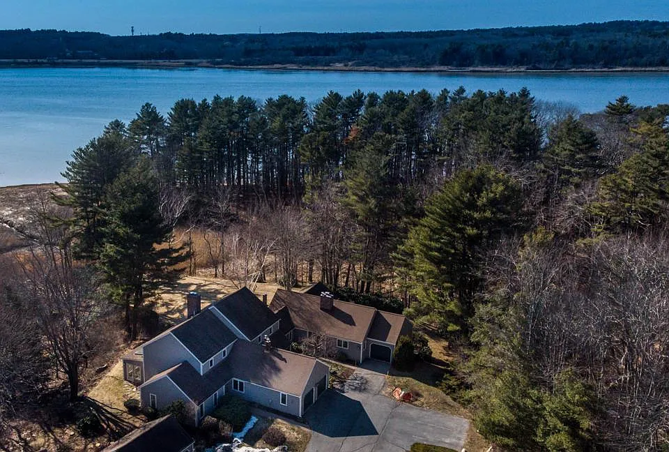 Location looking west over Penobscot River estuary. House is the lower side of image and closer half of the extension on right with 2 garages. Sunroom can be seen at left.