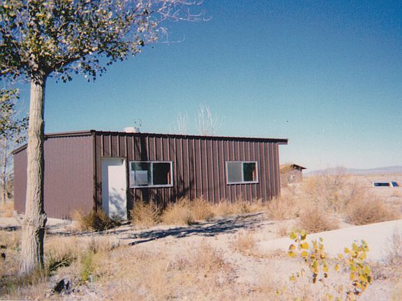30' x 30' steel shop building, edge of basketball court to the lower right.