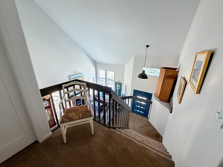 View looking down to entry way, living space from the upstairs bedrooms/baths