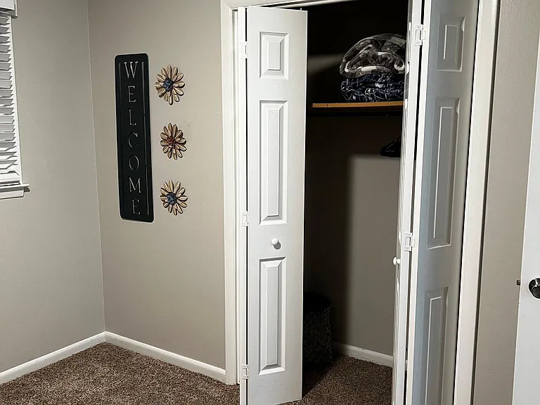 kids bedroom closet with extra blankets and games