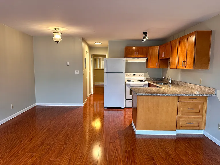 Kitchen with granite countertop, dishwasher, stove/range, refrigerator and dining area