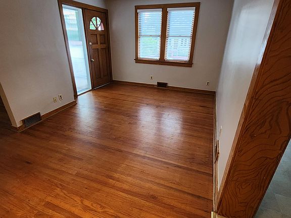 Living room, exit to front porch, exit to kitchen and family room, new blinds throughout.