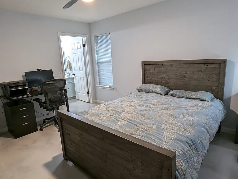 Another view of the master bedroom leading to the ensuite master bathroom at the corner of the picture