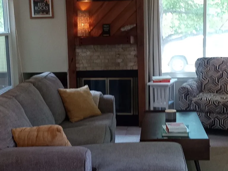 Living room with wood burning fireplace.