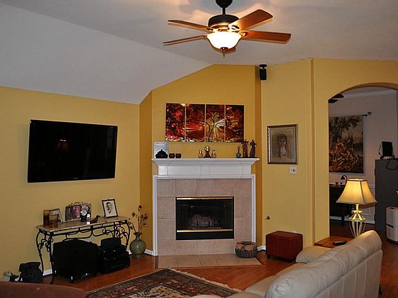  View of living room featuring wood floors,decorator colors,arched entryways.
