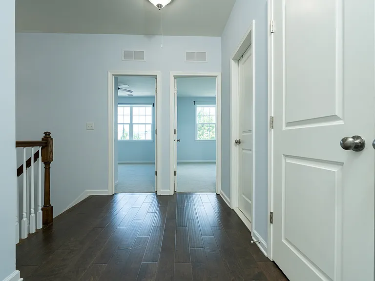 Hallway from other side with extra large linen closet and laundry