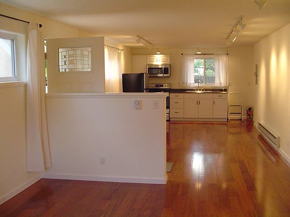 view from bedroom area toward kitchen and dining area