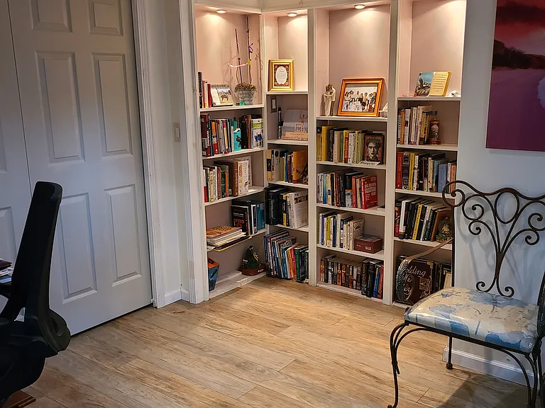 Built-in shelving in the finished basement living space that can ask as a 2nd living room or home office