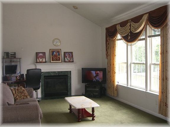 spacious family room with lots of windows, cathedral ceiling and fireplace