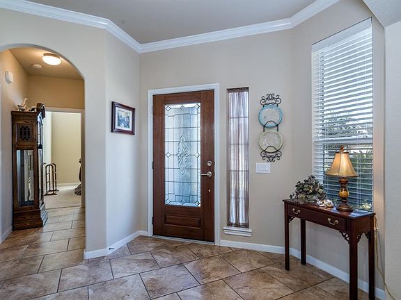 A leaded glass door, sidelight and front window allows the natural light to flow into the space!