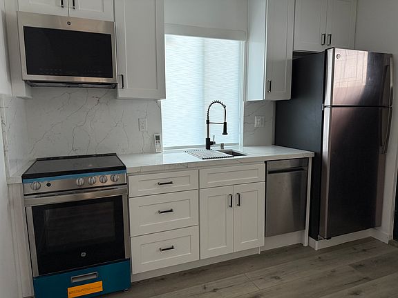 New Kitchen Refrigerator, Dishwasher, Range and Microwave.